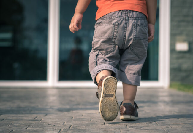 Child walking on tiles